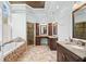 Luxurious bathroom with dual vanities, a soaking tub, and a tiled walk-in shower at 735 Amberton Close, Suwanee, GA 30024