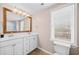 Bathroom featuring double vanity, an oversized mirror, and neutral walls at 735 Amberton Close, Suwanee, GA 30024