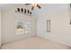 Bright bedroom with neutral carpet and a ceiling fan with wooden blades at 735 Amberton Close, Suwanee, GA 30024