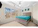 Bedroom with large windows, tray ceilings, carpet floors, and ceiling fan at 735 Amberton Close, Suwanee, GA 30024