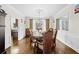 Elegant dining room featuring hardwood floors, a chandelier, and views through the large windows at 735 Amberton Close, Suwanee, GA 30024