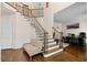 Spacious foyer with grand staircase and adjacent office area at 735 Amberton Close, Suwanee, GA 30024