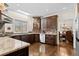 Well-equipped kitchen featuring granite countertops, custom cabinetry, and modern appliances at 735 Amberton Close, Suwanee, GA 30024