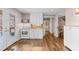 Kitchen featuring white cabinets, hardwood floors, and stainless steel appliances at 735 Amberton Close, Suwanee, GA 30024