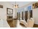 Bright living room featuring a stone fireplace, hardwood floors, and large windows at 735 Amberton Close, Suwanee, GA 30024
