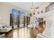 Spacious living room with hardwood floors, a wall of windows, and access to the kitchen at 735 Amberton Close, Suwanee, GA 30024