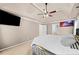 Large main bedroom with neutral walls, tray ceiling, and a fan with lighting at 735 Amberton Close, Suwanee, GA 30024