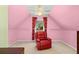 Sitting area with red leather recliner, shelves and decorative curtains at 735 Amberton Close, Suwanee, GA 30024