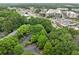 An aerial view showcasing a tree-lined apartment complex near shopping and roadways at 113 Tuxworth Cir, Decatur, GA 30033
