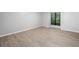 A bright bedroom with luxury vinyl flooring, a large window and neutral paint at 113 Tuxworth Cir, Decatur, GA 30033