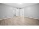Spacious bedroom with vinyl plank floors, neutral paint, and multiple closets at 113 Tuxworth Cir, Decatur, GA 30033