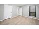 Bedroom with luxury vinyl floors, a large window, and a doorway to the en suite at 113 Tuxworth Cir, Decatur, GA 30033