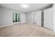 Bedroom with vinyl plank flooring, neutral paint, large window and access to a walk in closet at 113 Tuxworth Cir, Decatur, GA 30033
