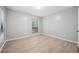 Bright bedroom with luxury vinyl flooring, large window, and neutral wall paint at 113 Tuxworth Cir, Decatur, GA 30033
