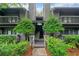 Exterior view of condo building with green landscaping, stairs, and wood siding at 113 Tuxworth Cir, Decatur, GA 30033