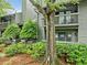 Exterior shot of condo building with green landscaping, wood siding, and a balcony at 113 Tuxworth Cir, Decatur, GA 30033