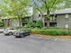Exterior shot of condo building with parking, green landscaping, and wood siding at 113 Tuxworth Cir, Decatur, GA 30033