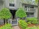Exterior of condo with green landscaping, wood siding,stairs, and a balcony at 113 Tuxworth Cir, Decatur, GA 30033