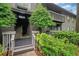 Exterior of condo with landscaping, wood siding, a balcony, and an entryway at 113 Tuxworth Cir, Decatur, GA 30033