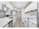 View of modern kitchen with marble countertops and open concept to living area at 113 Tuxworth Cir, Decatur, GA 30033