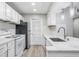 Bright kitchen features white cabinets, stainless steel appliances, and stone countertops at 113 Tuxworth Cir, Decatur, GA 30033