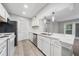 Bright kitchen features white cabinets, stainless steel appliances, and stone countertops at 113 Tuxworth Cir, Decatur, GA 30033