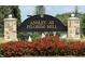 Community sign for Ansley at Pilgrim Mill surrounded by vibrant red flowers at 2385 Mayfair Dr, Cumming, GA 30040