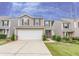 Charming two-story home featuring a manicured lawn, a two-car garage, and tasteful landscaping at 2385 Mayfair Dr, Cumming, GA 30040