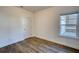 Bedroom featuring wood-look flooring, a window, and a white door at 2929 Rambler Dr, Loganville, GA 30052