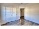 Bedroom featuring wood-look floors and white doors, with an open doorway leading to another room at 2929 Rambler Dr, Loganville, GA 30052