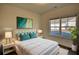 Bedroom featuring a queen bed with teal accents and bedside tables with lamps at 2929 Rambler Dr, Loganville, GA 30052