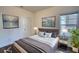Bedroom featuring a queen bed with contemporary artwork on the wall and a large window at 2929 Rambler Dr, Loganville, GA 30052