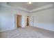 Large bedroom featuring a tray ceiling, neutral carpet, and walk-in closets at 2929 Rambler Dr, Loganville, GA 30052