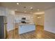 Modern kitchen with granite countertops, white cabinetry, and stainless appliances at 2929 Rambler Dr, Loganville, GA 30052