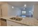 Bright kitchen island with granite countertop, sink, and pendant lighting at 2929 Rambler Dr, Loganville, GA 30052