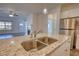 Kitchen island with granite countertop and stainless steel sink at 2929 Rambler Dr, Loganville, GA 30052