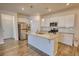 Modern kitchen features stainless steel appliances, granite counters, and a functional island at 2929 Rambler Dr, Loganville, GA 30052