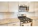 Close-up of a kitchen featuring stainless steel appliances and granite countertops at 2929 Rambler Dr, Loganville, GA 30052