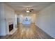 Bright living room with fireplace, ceiling fan, and an open floor plan flowing into the kitchen at 2929 Rambler Dr, Loganville, GA 30052