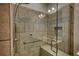 Walk-in shower with bench and patterned tile accent at 2929 Rambler Dr, Loganville, GA 30052