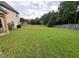 Spacious backyard with lush green lawn and mature trees, providing a serene and private outdoor space at 4482 Ridge Mill Ne Ter, Douglasville, GA 30135