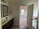 Bathroom with double sink vanity and tile flooring, leading to bedroom at 4482 Ridge Mill Ne Ter, Douglasville, GA 30135