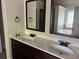 Bathroom features dual sink vanity with dark wood cabinets and framed mirrors at 4482 Ridge Mill Ne Ter, Douglasville, GA 30135
