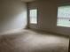 Neutral bedroom with two windows and plush carpet at 4482 Ridge Mill Ne Ter, Douglasville, GA 30135