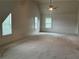 Large bonus room with vaulted ceiling, a ceiling fan and three windows providing ample natural light at 4482 Ridge Mill Ne Ter, Douglasville, GA 30135