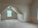 Bonus room featuring vaulted ceiling, a flush mount light and two windows providing natural light at 4482 Ridge Mill Ne Ter, Douglasville, GA 30135