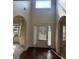 Bright foyer with dark wood floors, transom window, and arched doorways at 4482 Ridge Mill Ne Ter, Douglasville, GA 30135