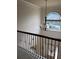 Grand foyer with a wrought iron railing and arched window at 4482 Ridge Mill Ne Ter, Douglasville, GA 30135