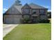 Charming two-story brick home with a well-kept lawn, inviting entryway, and a two-car garage at 4482 Ridge Mill Ne Ter, Douglasville, GA 30135