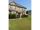 Charming brick two-story home with a well-manicured lawn and mature landscaping at 4482 Ridge Mill Ne Ter, Douglasville, GA 30135